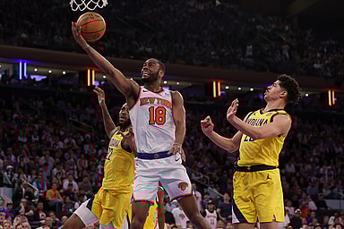 May 19, 2024; New York, New York, USA; New York Knicks guard Alec Burks (18) drives to the basket against Indiana Pacers forward Isaiah Jackson (22) and guard Ben Sheppard (26) during the fourth quarter of game seven of the second round of the 2024 NBA playoffs at Madison Square Garden. Mandatory Credit: Brad Penner-USA TODAY Sports