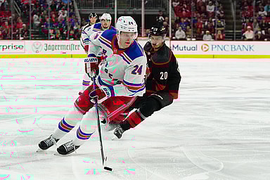 May 11, 2024; Raleigh, North Carolina, USA; New York Rangers right wing Kaapo Kakko (24) skates with the puck against Carolina Hurricanes center Sebastian Aho (20) during the second period in game four of the second round of the 2024 Stanley Cup Playoffs at PNC Arena. Mandatory Credit: James Guillory-USA TODAY Sports