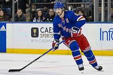 Apr 23, 2024; New York, New York, USA;  New York Rangers defenseman Jacob Trouba (8) skates with the puck against the Washington Capitals during the first period in game two of the first round of the 2024 Stanley Cup Playoffs at Madison Square Garden. Mandatory Credit: Dennis Schneidler-USA TODAY Sports