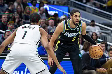 Mar 16, 2024; Indianapolis, Indiana, USA;  Indiana Pacers guard Tyrese Haliburton (0) dribbles the ball while Brooklyn Nets forward Mikal Bridges (1) (New York Knicks)defends in the first half at Gainbridge Fieldhouse. Mandatory Credit: Trevor Ruszkowski-USA TODAY Sports