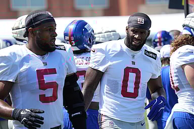 Jul 26, 2024; East Rutherford, NJ, USA; New York Giants linebacker Kayvon Thibodeaux (5) and New York Giants linebacker Brian Burns (0) break on the sideline during training camp at Quest Diagnostics Training Center. Mandatory Credit: Lucas Boland-USA TODAY Sports