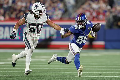Sep 26, 2024; East Rutherford, New Jersey, USA; New York Giants wide receiver Darius Slayton (86) bobbles the ball as he runs against Dallas Cowboys linebacker Eric Kendricks (50) during the second quarter at MetLife Stadium. Mandatory Credit: Brad Penner-Imagn Images