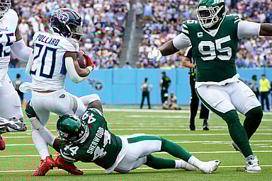 Tennessee Titans running back Tony Pollard (20) is tackled by New York Jets linebacker Jamien Sherwood (44) during the second quarter at Nissan Stadium in Nashville, Tenn., Sunday, Sept. 15, 2024.