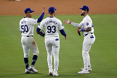 Oct 13, 2024; Los Angeles, California, USA; Los Angeles Dodgers shortstop Mookie Betts (50) reacts with outfielder Andy Pages (44) and outfielder Kevin Kiermaier (93)  teammates after the ninth inning during game one of the NLCS for the 2024 MLB Playoffs at Dodger Stadium.  Mandatory Credit: Jason Parkhurst-Imagn Images