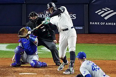 Oct 30, 2024; New York, New York, USA; New York Yankees outfielder Aaron Judge (99) hits a double during the eighth inning against the Los Angeles Dodgers in game four of the 2024 MLB World Series at Yankee Stadium. Mandatory Credit: Robert Deutsch-Imagn Images