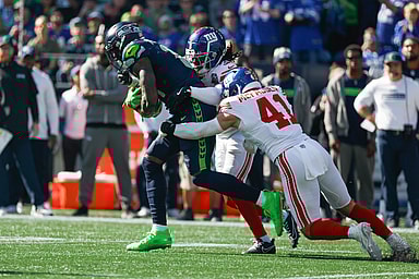 Oct 6, 2024; Seattle, Washington, USA; Seattle Seahawks wide receiver DK Metcalf (14) runs for yards after the catch against New York Giants cornerback Deonte Banks (3) and linebacker Micah McFadden (41) during the first quarter at Lumen Field. Mandatory Credit: Joe Nicholson-Imagn Images