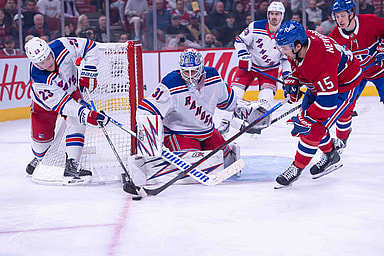 Oct 22, 2024; Ottawa, Ontario, CAN; New York Rangers defenseman Adam Fox (23) battles with Montreal Canadiens center Alex Newhook (15) for control of the puck in the second period at the Bell Centre. Mandatory Credit: Marc DesRosiers-Imagn Images