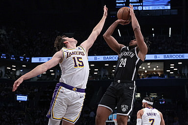 Mar 31, 2024; Brooklyn, New York, USA; Brooklyn Nets guard Cam Thomas (24) shoots the ball against Los Angeles Lakers guard Austin Reaves (15) during the first half at Barclays Center. Mandatory Credit: Vincent Carchietta-Imagn Images