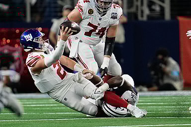 Nov 28, 2024; Arlington, Texas, USA;  New York Giants quarterback Drew Lock (2) is sacked by Dallas Cowboys defensive end Carl Lawson (55) during the second half at AT&T Stadium. Mandatory Credit: Chris Jones-Imagn Images