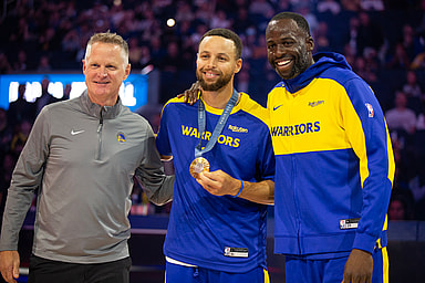 Oct 11, 2024; San Francisco, California, USA; Golden State Warriors guard Stephen Curry (center) is flanked by head coach Steve Kerr and forward Draymond Green as he is presented his gold medal for his performance for Team USA at the 2024 Summer Olympics in Paris before taking on the Sacramento Kings at Chase Center. Mandatory Credit: D. Ross Cameron-Imagn Images