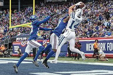 Dec 29, 2024; East Rutherford, New Jersey, USA; Indianapolis Colts wide receiver Alec Pierce (14) catches a touchdown pass as New York Giants safety Jason Pinnock (27) and cornerback Cor'Dale Flott (28) defend during the second half at MetLife Stadium. Mandatory Credit: Vincent Carchietta-Imagn Images