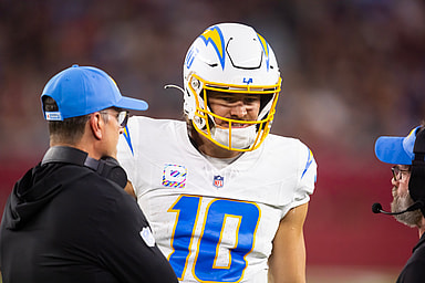 Oct 21, 2024; Glendale, Arizona, USA; Los Angeles Chargers quarterback Justin Herbert (10) with head coach Jim Harbaugh against the Arizona Cardinals at State Farm Stadium. Mandatory Credit: Mark J. Rebilas-Imagn Images