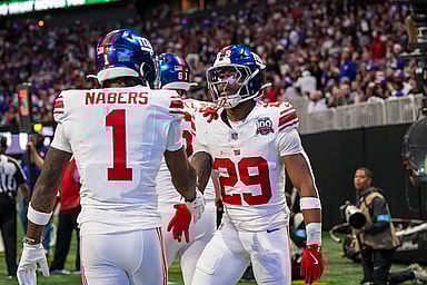 Dec 22, 2024; Atlanta, Georgia, USA; New York Giants running back Tyrone Tracy Jr. (29) reacts with wide receiver Malik Nabers (1) after catching a touchdown pass against the Atlanta Falcons during the first half at Mercedes-Benz Stadium. Mandatory Credit: Dale Zanine-Imagn Images