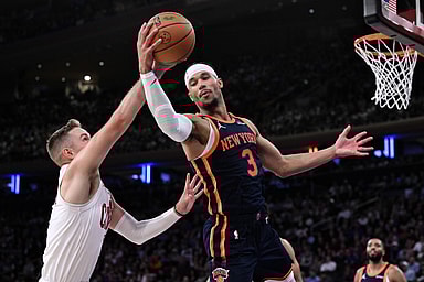 Oct 28, 2024; New York, New York, USA; New York Knicks guard Josh Hart (3) grabs a rebound against Cleveland Cavaliers guard Sam Merrill (5) during the second half at Madison Square Garden. Mandatory Credit: John Jones-Imagn Images