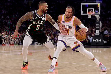 Jan 12, 2025; New York, New York, USA; New York Knicks guard Jalen Brunson (11) controls the ball against Milwaukee Bucks guard Damian Lillard (0) during the first quarter at Madison Square Garden. Mandatory Credit: Brad Penner-Imagn Images