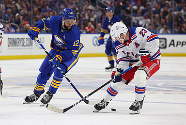 Buffalo Sabres left wing Jordan Greenway (12) and New York Rangers defenseman Adam Fox (23) go after a loose puck during the third period at KeyBank Center