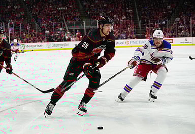 May 9, 2024; Raleigh, North Carolina, USA; Carolina Hurricanes center Martin Necas (88) skates with the puck past New York Rangers defenseman Ryan Lindgren (55) during the third period in game three of the second round of the 2024 Stanley Cup Playoffs at PNC Arena. Mandatory Credit: James Guillory-USA TODAY Sports