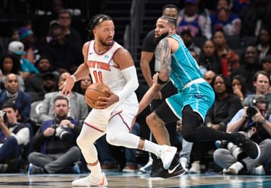 New York Knicks guard Jalen Brunson (11) moves past Charlotte Hornets forward Cody Martin (11) during the second half at the Spectrum Center