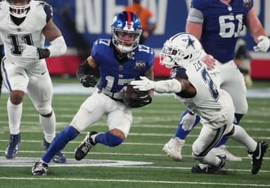 Sep 26, 2024; East Rutherford, New Jersey, USA;  New York Giants wide receiver Wan'Dale Robinson (17) runs past Dallas Cowboys cornerback Jourdan Lewis (2) during the second half at MetLife Stadium. Mandatory Credit: Robert Deutsch-Imagn Images