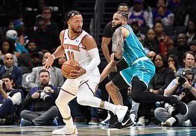 New York Knicks guard Jalen Brunson (11) moves past Charlotte Hornets forward Cody Martin (11) during the second half at the Spectrum Center
