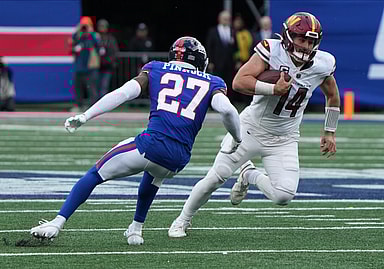 Jason Pinnock of the Giants chases Sam Howell of the Commanders in the second half. The NY Giants host the Washington Commanders at MetLife Stadium