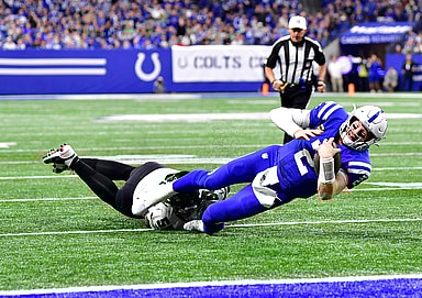 Indianapolis Colts quarterback Carson Wentz (2) is tackled short of the end zone by New York Jets defensive end Shaq Lawson (50) during the second half at Lucas Oil Stadium