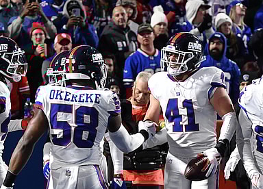 New York Giants linebacker Micah McFadden (41) celebrates with teammates (Bobby Okereke) after making an interception in the second quarter at Highmark Stadium.
