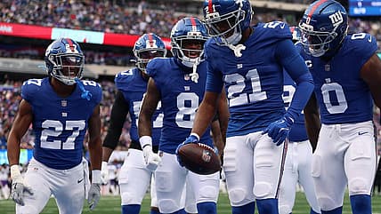 Paulson Adebo celebrates after a turnover for the Giants