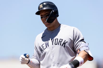 Aaron Judge smiles in the Yankees dugout against the Athletics