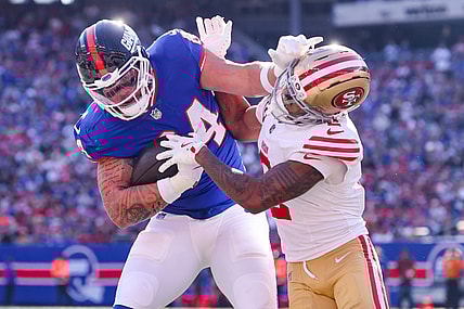 Nov 2, 2025; East Rutherford, New Jersey, USA; New York Giants tight end Theo Johnson (84) runs after the catch for a touchdown as San Francisco 49ers cornerback Deommodore Lenoir (2) defends during the first half at MetLife Stadium. Mandatory Credit: Ed Mulholland-Imagn Images