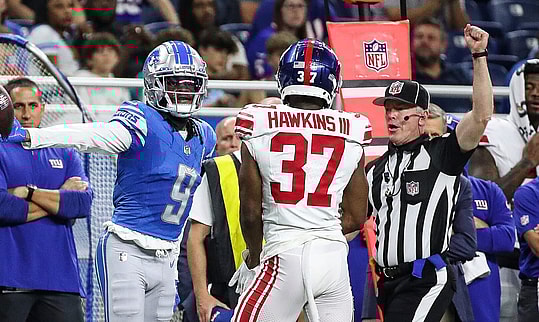 Detroit Lions wide receiver Jameson Williams (9) reacts to a first down catch against New York Giants cornerback Tre Hawkins III (37) during the first half of a preseason game at Ford Field in Detroit on Friday
