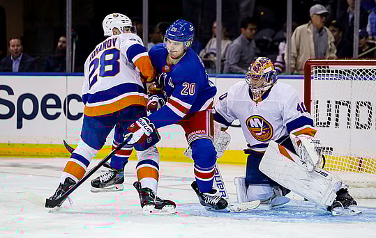Sep 24, 2024; New York, New York, USA; New York Rangers left wing Chris Kreider (20) tries to deflect a shot while in between New York Islanders defenseman Alexander Romanov (28) and New York Islanders goalie Semyon Varlamov (40) during the first period at Madison Square Garden. Mandatory Credit: Danny Wild-Imagn Images