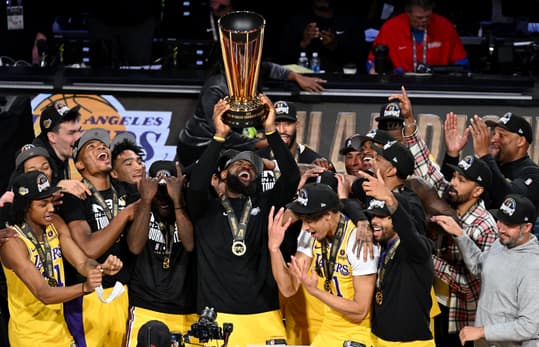 Dec 9, 2023; Las Vegas, Nevada, USA; Los Angeles Lakers forward LeBron James (23) hoists the NBA Cup and celebrates with teammates after winning the NBA In-Season Tournament Championship game against the Indiana Pacers at T-Mobile Arena. Mandatory Credit: Candice Ward-Imagn Images