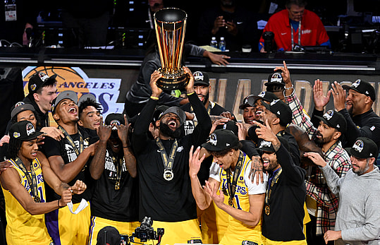 Dec 9, 2023; Las Vegas, Nevada, USA; Los Angeles Lakers forward LeBron James (23) hoists the NBA Cup and celebrates with teammates after winning the NBA In-Season Tournament Championship game against the Indiana Pacers at T-Mobile Arena. Mandatory Credit: Candice Ward-Imagn Images