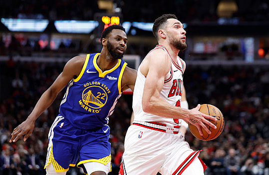 Jan 12, 2024; Chicago, Illinois, USA; Chicago Bulls guard Zach LaVine (8) drives against Golden State Warriors forward Andrew Wiggins (22) during the second half at United Center. Mandatory Credit: Kamil Krzaczynski-Imagn Images