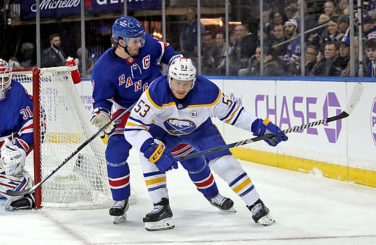 Nov 27, 2023; New York, New York, USA; New York Rangers defenseman Jacob Trouba (8) battles for the puck with Buffalo Sabres left wing Jeff Skinner (53) during the first period at Madison Square Garden. Mandatory Credit: Danny Wild-USA TODAY Sports