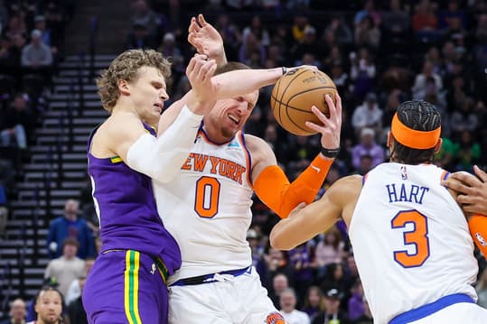 New York Knicks guard Donte DiVincenzo (0) is fouled by Utah Jazz forward Lauri Markkanen (23) during an inbound pass in the last few seconds of the game at Delta Center