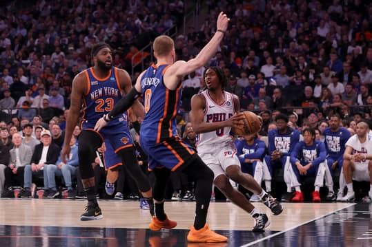 Apr 30, 2024; New York, New York, USA; Philadelphia 76ers guard Tyrese Maxey (0) drives to the basket against New York Knicks center Mitchell Robinson (23) and guard Donte DiVincenzo (0) during the second quarter of game 5 of the first round of the 2024 NBA playoffs at Madison Square Garden. Mandatory Credit: Brad Penner-USA TODAY Sports