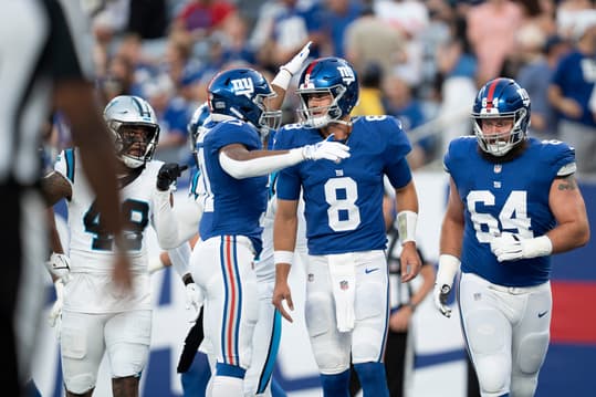 Aug 18, 2023; East Rutherford, NJ, USA; The Carolina Panthers vs. the New York Giants in an NFL preseason game at MetLife Stadium. New York Giants quarterback Daniel Jones (8) celebrates after throwing a pass for a touchdown in the first quarter. Mandatory Credit: Michael Karas-The Record