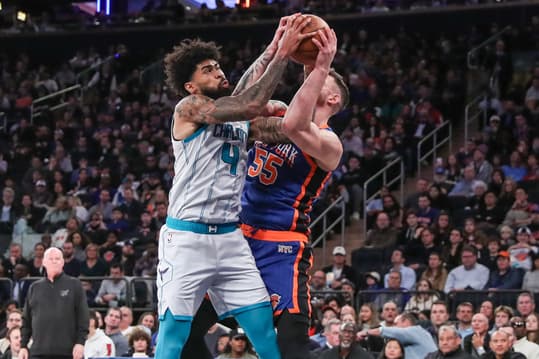 Nov 12, 2023; New York, New York, USA;  Charlotte Hornets center Nick Richards (4) and New York Knicks center Isaiah Hartenstein (55) fight for a rebound in the third quarter at Madison Square Garden. Mandatory Credit: Wendell Cruz-USA TODAY Sports