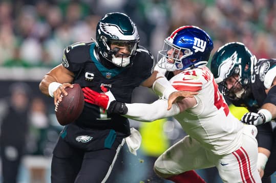 Dec 25, 2023; Philadelphia, Pennsylvania, USA; Philadelphia Eagles quarterback Jalen Hurts (1) eludes the rush of New York Giants linebacker Micah McFadden (41) during the second quarter at Lincoln Financial Field. Mandatory Credit: Bill Streicher-USA TODAY Sports