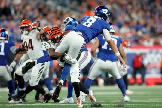 Oct 13, 2024; East Rutherford, New Jersey, USA; Cincinnati Bengals cornerback Mike Hilton (21) hits New York Giants quarterback Daniel Jones (8) after a pass during the third quarter at MetLife Stadium. Mandatory Credit: Brad Penner-Imagn Images