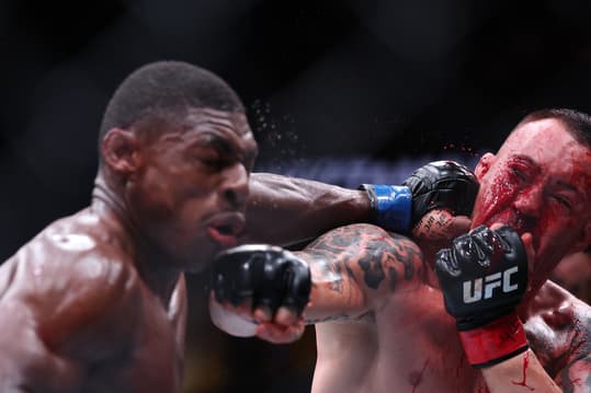 Dec 14, 2024; Tampa, Florida, UNITED STATES; Colby Covington (red gloves) fights Joaquin Buckley (blue gloves) at Amalie Arena. Mandatory Credit: Nathan Ray Seebeck-Imagn Images
