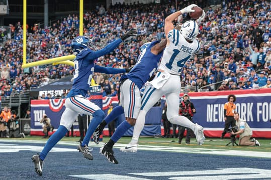 Dec 29, 2024; East Rutherford, New Jersey, USA; Indianapolis Colts wide receiver Alec Pierce (14) catches a touchdown pass as New York Giants safety Jason Pinnock (27) and cornerback Cor'Dale Flott (28) defend during the second half at MetLife Stadium. Mandatory Credit: Vincent Carchietta-Imagn Images