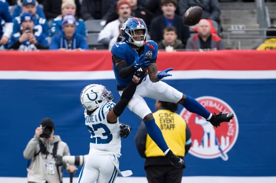 New York Giants wide receiver Malik Nabers (1) catches a pass in the air while being guarded by Indianapolis Colts defensive back Kenny Moore II (23) during a game between New York Giants and Indianapolis Colts at MetLife Stadium on Sunday, Dec. 29, 2024.