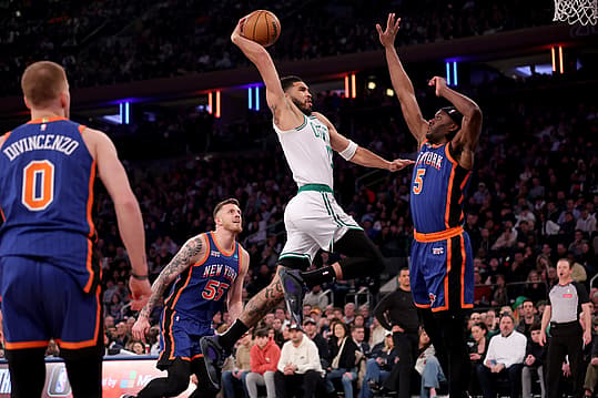 Feb 24, 2024; New York, New York, USA; Boston Celtics forward Jayson Tatum (0) drives to the basket against New York Knicks forward Precious Achiuwa (5) and center Isaiah Hartenstein (55) and guard Donte DiVincenzo (0) during the first quarter at Madison Square Garden. Mandatory Credit: Brad Penner-USA TODAY Sports