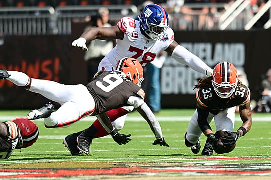 Sep 22, 2024; Cleveland, Ohio, USA; Cleveland Browns safety Ronnie Hickman (33) recovers a fumble in front of New York Giants offensive tackle Andrew Thomas (78) during the second half at Huntington Bank Field. Mandatory Credit: Ken Blaze-Imagn Images