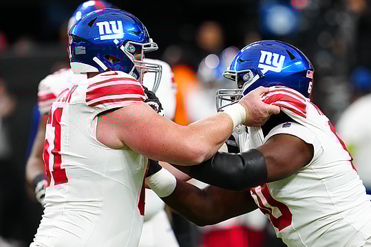 New York Giants center John Michael Schmitz Jr. (61) warms up with New York Giants guard Marcus McKethan (60) before a game against the Las Vegas Raiders at Allegiant Stadium
