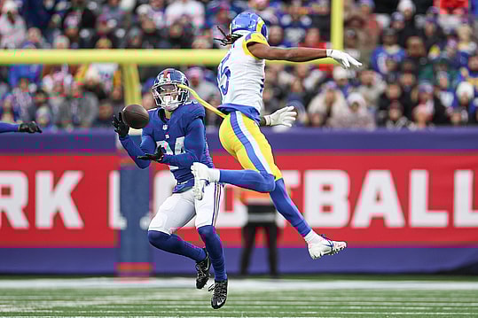 New York Giants safety Dane Belton (24) intercepts a pass intended for Los Angeles Rams wide receiver Demarcus Robinson (15) during the second half at MetLife Stadium