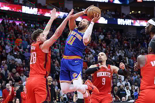 New York Knicks guard Jalen Brunson (11) attempts to score as Houston Rockets center Alperen Sengun (28) defends during the fourth quarter at Toyota Center